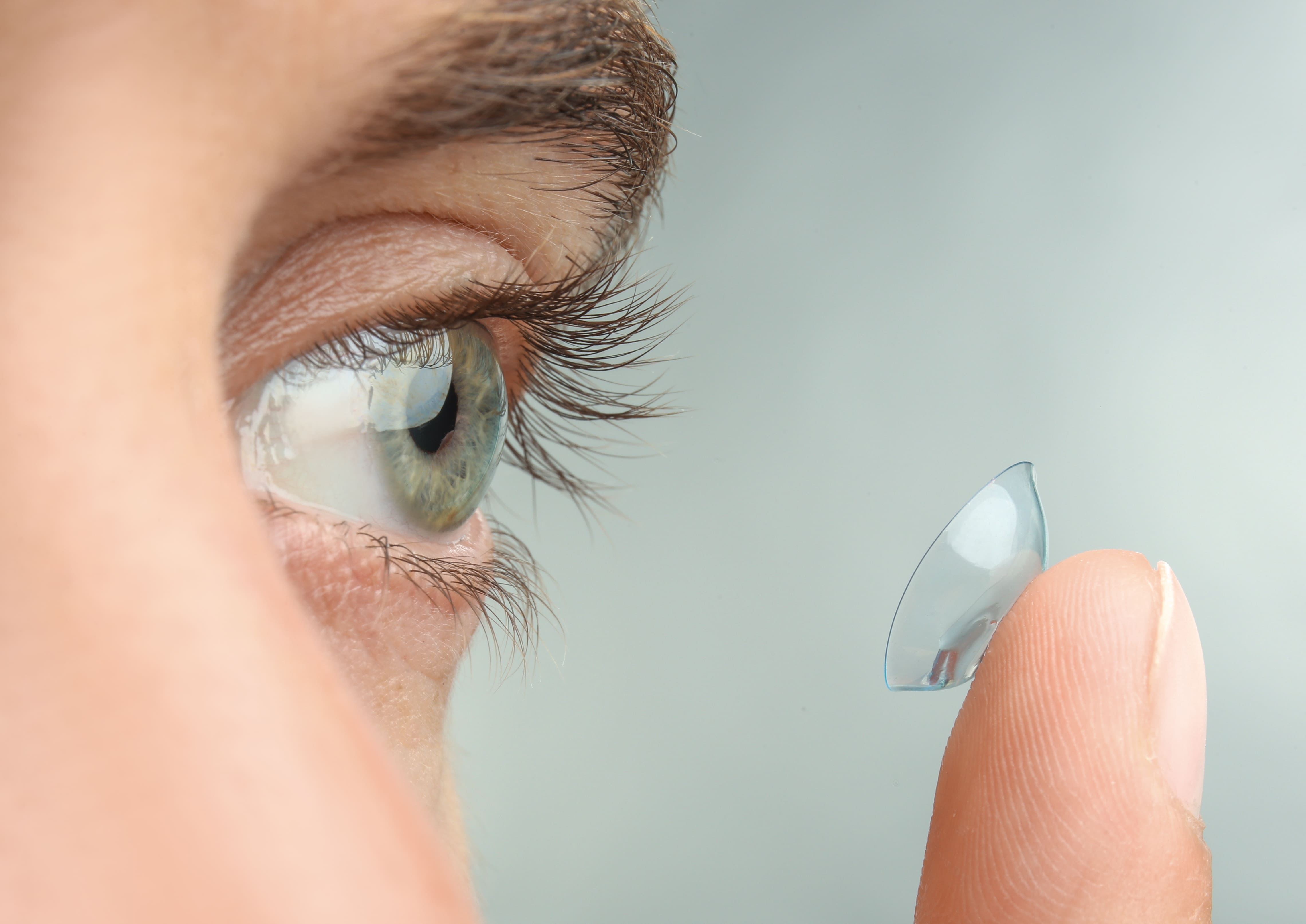 woman fitting contact lens